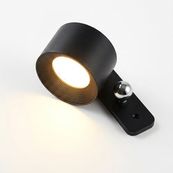 Unik liten vägglampa i svart som kan fästas på väggen med en fjärrkontroll.
