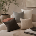 Bouclé pillow cases in natural colors on a nice couch.