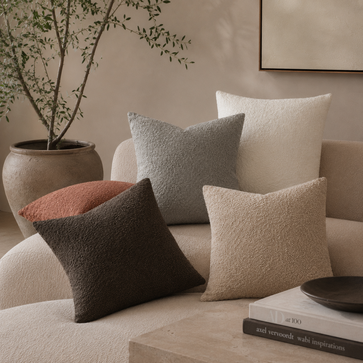 Bouclé pillow cases in natural colors on a nice couch.
