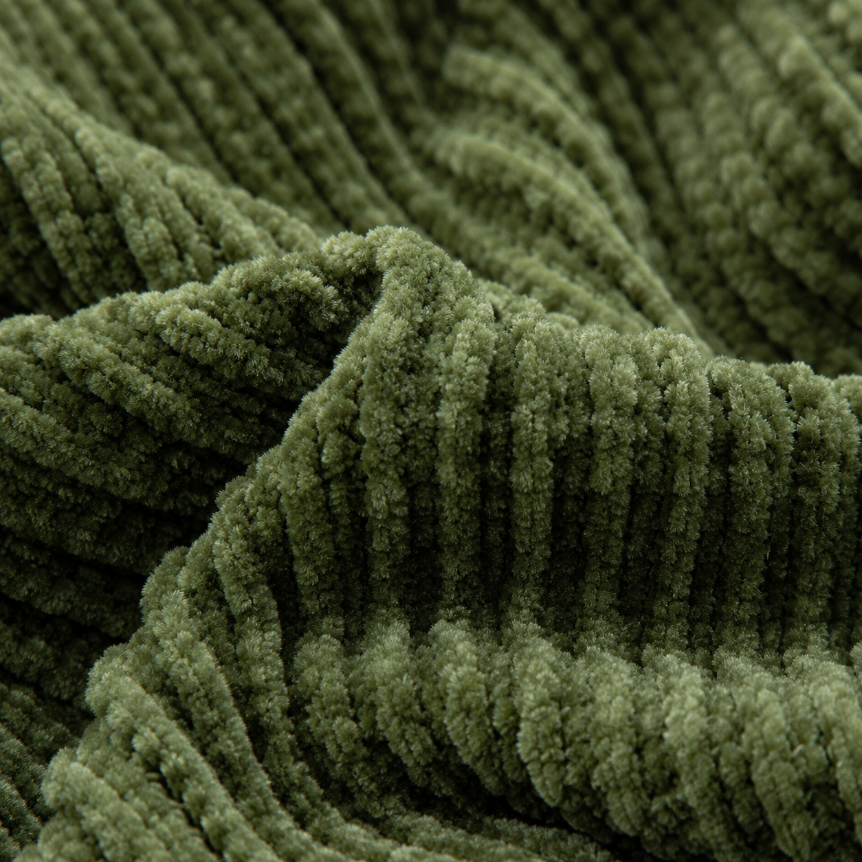 Detaljebilde av mykt chenille pledd