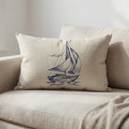 Fin hvit og blå maritim pute i en lys sofa. 