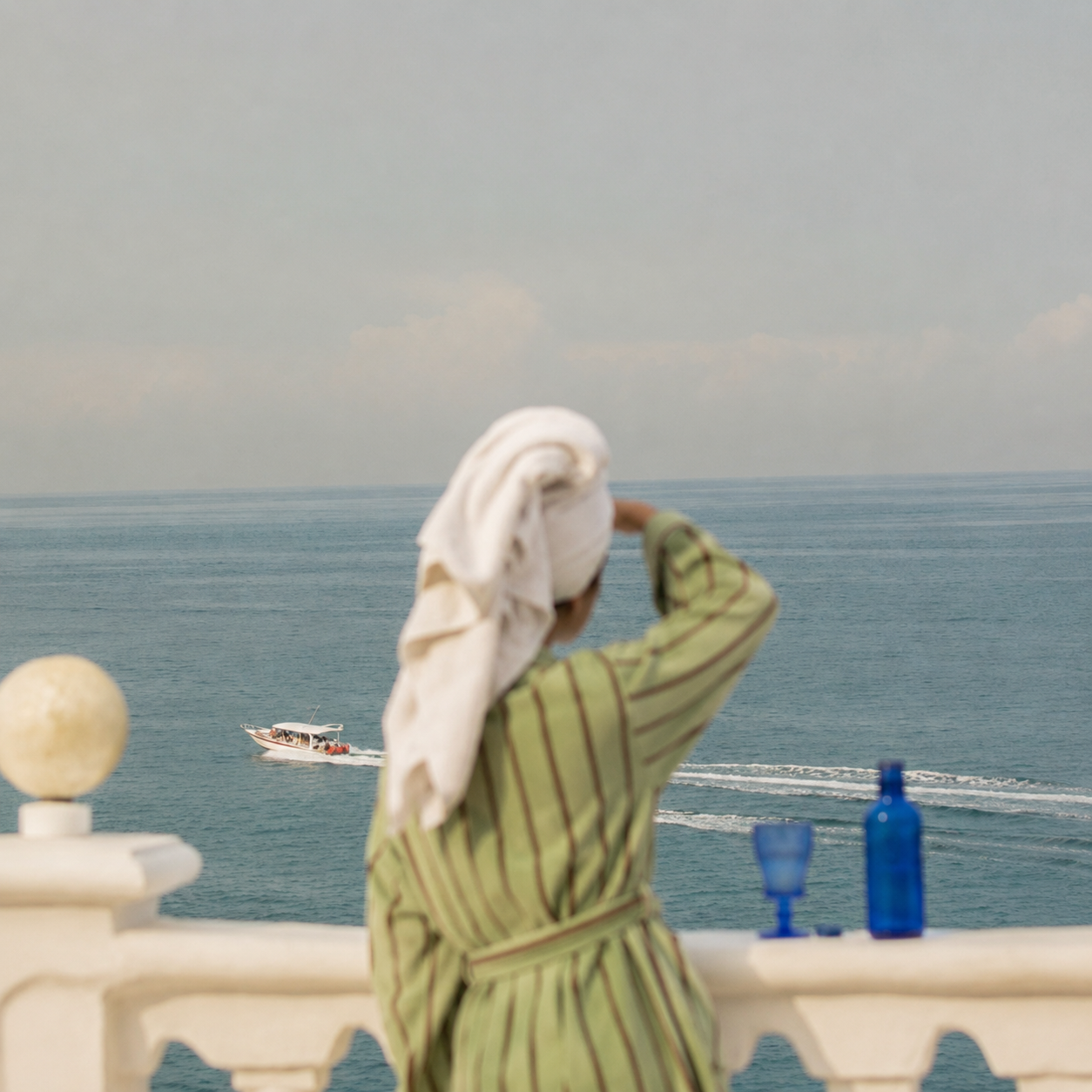 Lady looking out to sea with her green robe.