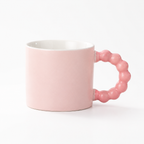 Pink coffee cup in a white studio