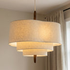 Fin japansk nordisk taklampe i stoff og tre i en stue.