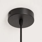 Closeup of ceiling attachment in black in a white studio. 