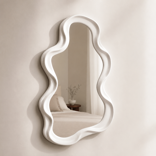 White frame small mirror on a wall