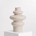 Wavy vase in ceramic in a white studio. 